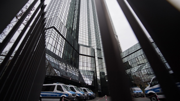 Police vans sit outside the headquarters of Deutsche Bank AG during a police raid in Frankfurt, Germany, on Thursday, Nov. 29, 2018. Deutsche Bank's premises including its headquarters in Frankfurt were being searched by prosecutors on Thursday in a money laundering probe, prosecutors said in a statement. 
