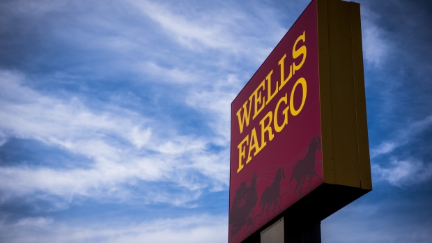 Signage stands outside a Wells Fargo & Co. bank branch in Evanston, Illinois, U.S., on Tuesday, July 10, 2018. Wells Fargo & Co. is scheduled to release earnings figures on July 13. 