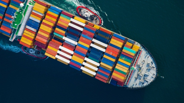 Tugboats help guide a Mediterranean Shipping Co. (MSC) ship loaded with freight containers in this aerial photograph approaching the Port of Long Beach in Long Beach, California, U.S., on Friday, Feb. 1, 2013. The U.S. Census Bureau is scheduled to release trade balance figures on Feb. 8. 