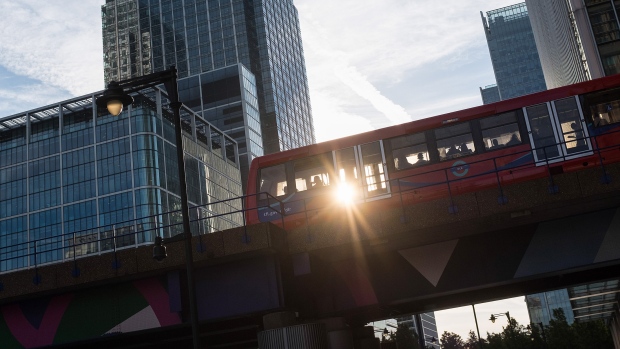 A Docklands Light Railway (DLR) train travels from Heron Quay through the Canary Wharf financial, business and shopping district in London, U.K., on Monday, Aug. 14, 2017. The Docklands Light Railway, a low-capacity rail system connecting the City of London to the Docklands area that carries 122 million passengers a year, began operating on Aug. 31, 1987. 