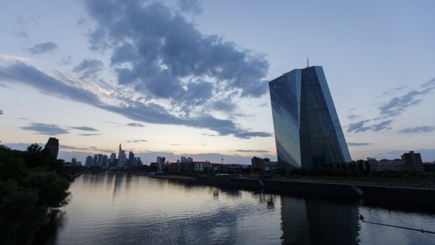 The European Central Bank (ECB) skyscraper headquarters stand beside the River Main at dusk in Frankfurt, Germany. Photographer: Alex Kraus/Bloomberg