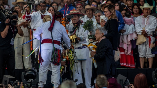 Lopez Obrador kneels for a ceremony during the Presidential Inauguration Photographer: Alejandro Cegarra/Bloomberg