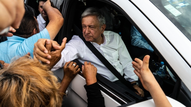 Andres Manual Lopez Obrador, Mexico's president, center, greets attendees after a rally while visiting flood zone victims of Hurricane Willa in the town of Acaponeta, Nyarit state, Mexico, on Friday, Dec. 7, 2018. Details of Mexico's 2019 budget proposal due next week will be important to watch for investors, JPMorgan economist Gabriel Lozano writes in a note. Photographer: Cesar Rodriguez/Bloomberg
