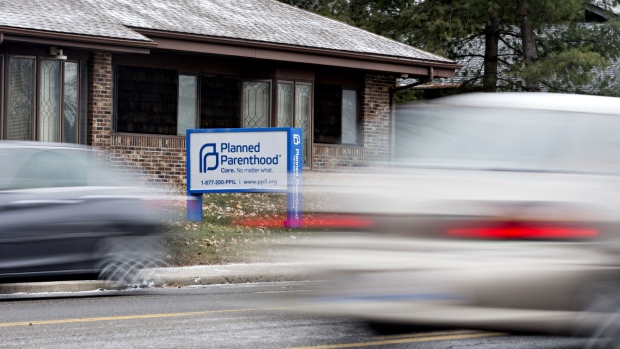 Vehicles drive past a Planned Parenthood office in Peoria, Illinois, U.S., on Friday, Dec. 16, 2016. Republicans are thinking ahead to regulations Obama might still try to complete before he leaves office, including a pending rule barring states from blocking funds to Planned Parenthood. 