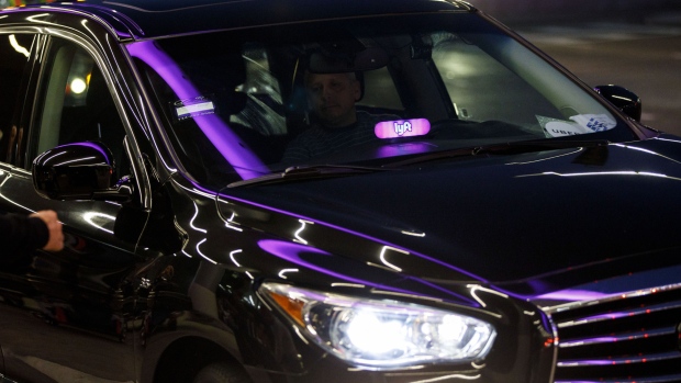 An illuminated Lyft Inc. sign is seen on the dashboard of a ride share vehicle at Los Angeles International Airport (LAX) in Los Angeles, California, U.S., on Monday, Nov. 13, 2017. Lyft Inc. has gained significant ground on its rival, Uber Technologies Inc., and is expected to grab more market share in the U.S., according to a private Lyft investor document obtained by Bloomberg. 