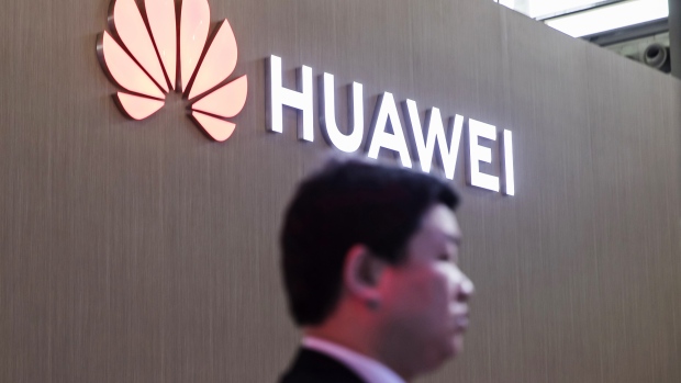 The Huawei Technologies Co. logo is displayed at the company's booth at the CES Asia 2018 show in Shanghai, China, on Wednesday, June 13, 2018. The show runs through June 15. 