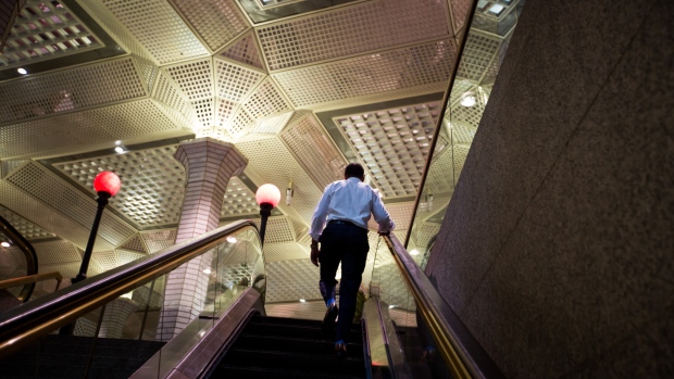 A commuter exits the Wall Street subway station near the New York Stock Exchange (NYSE) in New York. 