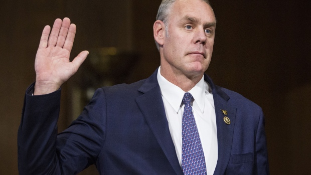 Representative Ryan Zinke, U.S. secretary of interior nominee for president-elect Donald Trump, is sworn in to a Senate Energy and Natural Resources Committee confirmation hearing in Washington, D.C., U.S., on Tuesday, Jan. 17, 2017. Zinke, Trump's pick to head the Interior Department, earned $85,000 from a company that has a stock price of 8 cents, an accumulated deficit of more than $100 million and no customers. Photographer: Zach Gibson/Bloomberg