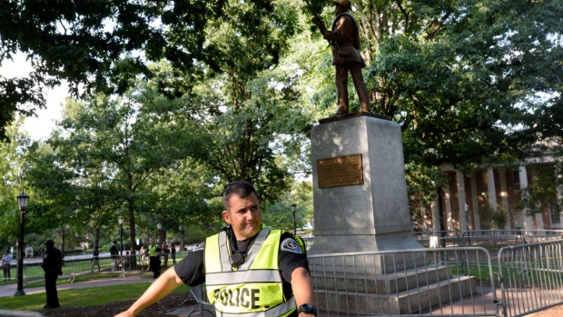 CHAPEL HILL, NC - AUGUST 22: A Confederate statue, coined Silent Sam, is guarded by two layers of fence, chain and police on the campus of the University of Chapel Hill on August 22, 2017 in Chapel Hill North Carolina. Demonstrators rallied for its removal. (Photo by Sara D. Davis/Getty Images)