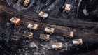 Heavy haulers are seen at the Suncor Energy Inc. Fort Hills mine in this aerial photograph taken above the Athabasca oil sands near Fort McMurray, Alberta, Canada, on Monday, Sept. 10, 2018. While the upfront spending on a mine tends to be costlier than developing more common oil-sands wells, their decades-long lifespans can make them lucrative in the future for companies willing to wait. 