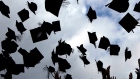 Students throw their mortarboards in the air during their graduation photograph at the University of Birmingham degree congregations on July 14, 2009 