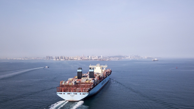 The Marit Maersk cargo ship operated by A.P. Moller-Maersk A/S sets sail from the Qingdao Qianwan Container Terminal in Qingdao, China, on Monday, May 7, 2018. China's overseas shipments exceeded estimates while imports surged, as the global economy continued to support demand. 
