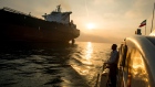 A support vessel flying an Iranian national flag sails alongside the oil tanker 'Devon' as it prepar