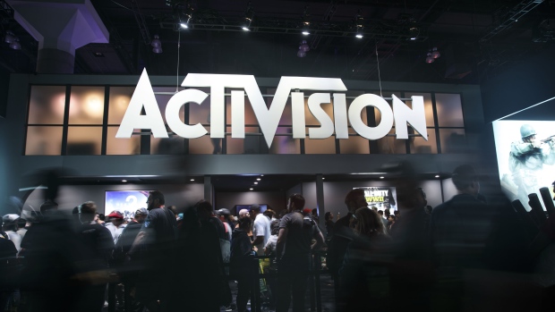 Attendees walk past Activision Blizzard Inc. signage during the E3 Electronic Entertainment Expo in Los Angeles, California, U.S., on Wednesday, June 14, 2017. 