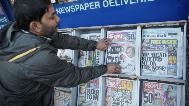 LEATHERHEAD, ENGLAND - FEBRUARY 26: A newsagent places copies of the first ever edition of The Sun on Sunday oustide his convenience store on February 26, 2012 in Leatherhead, England. Rupert Murdoch's News International closed the News of The World Sunday tabloid newspaper in 2011 after revelations of phone hacking and it's new Sunday newspaper was launched today with an initial print run of three million copies. (Photo by Peter Macdiarmid/Getty Images)