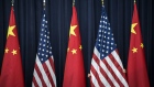 A staff member adjusts an American flag before the opening session of the U.S. and China Strategic and Economic Dialogue, in Washington, D.C.