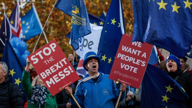 Anti-Brexit campaigners shout slogans outside the Houses of Parliament in the Westminster district of London, U.K., on Monday, Nov. 19, 2018. Ever since Prime Minister Theresa May announced her Brexit deal, she has sought to go over the heads of her critics and appeal directly to voters to back her plan. 