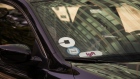 Lyft and Uber logos are seen on the windshield of a vehicle in New York. 