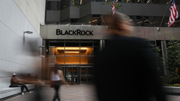 Pedestrians walk past BlackRock Inc. headquarters in New York, U.S, on Wednesday, June 11, 2018. 