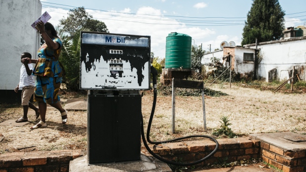 A weather-beaten Exxon Mobil Corp. branded fuel pump stands outside a garage in Harare, Zimbabwe, on Tuesday, July 31, 2018. Zimbabwe's main opposition party said it was well ahead in the first election of the post-Robert Mugabe era and it's ready to form the next government, as unofficial results began streaming in. 