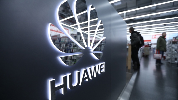 A Huawei Technologies Co. logo sits on display as customers browse inside a Media Markt electronic goods store, operated by Ceconomy AG, in Berlin, Germany, on Monday, Dec. 17, 2018. Ceconomy announce full year earnings figures on Dec. 19. 