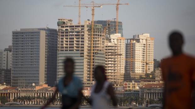 Construction cranes operate among new skyscrapers being built in the business district of Luanda, Angola, on Saturday, Nov. 9, 2013. 