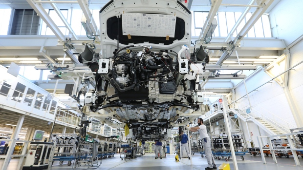 A Volkswagen Tiguan hangs from a cradle on the assembly line at the Volkswagen AG (VW) factory in Wolfsburg. 