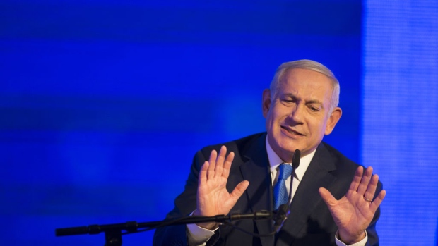 RAMAT GAN, ISRAEL - DECEMBER 02: (ISRAEL OUT) Israeli Prime Minister Benjamin Netanyahu gestures while delivering a speech before lighting a stylised-menorah during the start of Hanukkah, the Jewish festival of lights on December 2, 2018 in Ramat Gan, Israel. Earlier today, police and Israel Securities Authority recommended indicting Netanyahu and his wife, Sara, for bribery and other corruption charges. (Photo by Lior Mizrahi/Getty Images)
