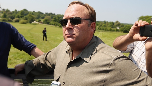 WATFORD, ENGLAND - JUNE 06: Alex Jones (C), an American radio host, author and conspiracy theorist, addresses media and protesters in the protester encampment outside The Grove hotel, which is hosting the annual Bilderberg conference, on June 6, 2013 in Watford, England. The traditionally secretive conference, which has taken place since 1954, is expected to be attended by politicians, bank bosses, billionaires, chief executives and European royalty. (Photo by Oli Scarff/Getty Images)