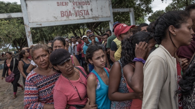 Venezuelan migrants wait in line to receive food donations at Simon Bolivar Square in Boa Vista, Roraima state, Brazil, on Feb. 17, 2018. 