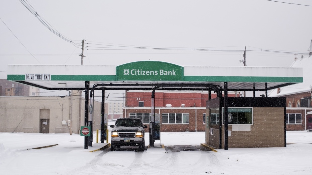 A customer uses the drive through teller lane at a Citizens Financial Group Inc. bank branch as snow falls in downtown Portsmouth, Ohio. 