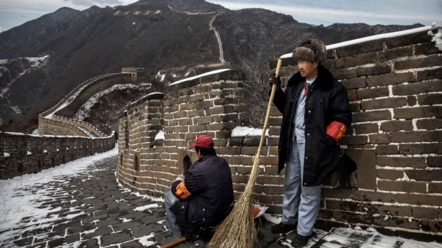 BEIJING, CHINA - FEBRUARY 22: Chinese workers take a break from shovelling and sweeping after a snowfall on the Great Wall in Mutianyu on February 22, 2017 outside of Beijing, China. (Photo by Kevin Frayer/Getty Images)