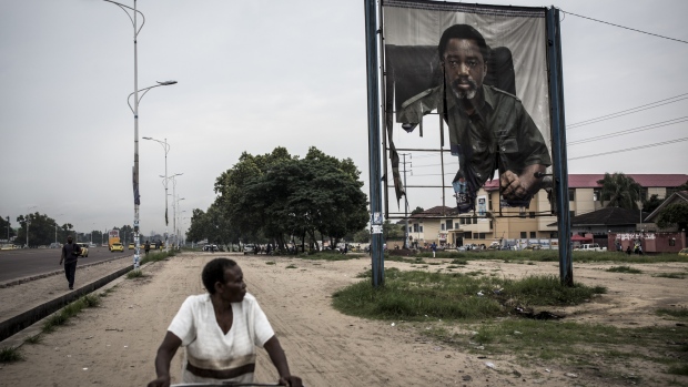 A fire-damaged banner featuring Joseph Kabila, Congo's outgoing president, stands by the roadside in Kinshasa, Democratic Republic of the Congo, on Friday, Jan. 11, 2019. The disputed presidential election result could lead to legal challenges and a prolonged period of political uncertainty -- the last thing that's needed in a nation already confronting rampant poverty and insecurity. Photographer: John Wessels/Bloomberg