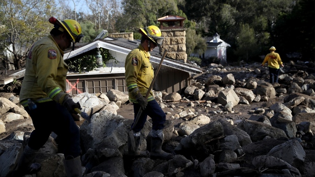 MONTECITO, CA - JANUARY 10: Firefighters search for people trapped in mudslide debris on January 10, 2018 in Montecito, California. 15 people have died and hundreds are still stranded after massive mudslides crashed through Montecito, California early Tuesday morning. (Photo by Justin Sullivan/Getty Images)