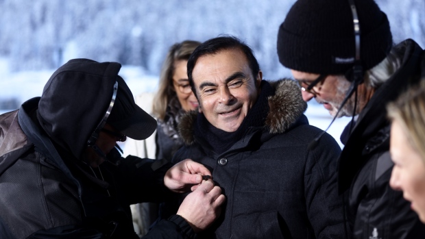 Carlos Ghosn, chief executive officer of Nissan Motor Co. and Renault SA, has his microphone adjusted ahead of a Bloomberg Television interview in Davos, Switzerland, on Thursday, Jan. 21, 2016. World leaders, influential executives, bankers and policy makers attend the 46th annual meeting of the World Economic Forum in Davos from Jan. 20 - 23. Photographer: Simon Dawson/Bloomberg *** Local Caption *** Carlos Ghosn