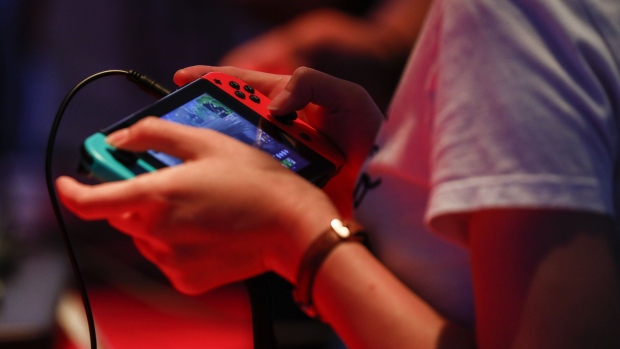 An attendee plays the Bethesda Softworks LLC Fallout: Shelter video game on a Nintendo Co. Switch console during the E3 Electronic Entertainment Expo in Los Angeles, California, U.S., in Los Angeles, California, U.S., on Wednesday, June 13, 2018. For three days, leading-edge companies, groundbreaking new technologies and never-before-seen products are showcased at E3. 