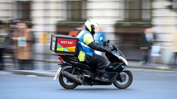 A food delivery courier, working for Just Eat Plc, travels in London, U.K., on Thursday, Dec. 22, 2016. The food delivery business model has proven attractive to venture capitalists, who last year poured $5.5 billion into food-delivery companies globally, according to research firm CB Insights. 