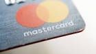 A Mastercard Inc. credit card is arranged for a photograph in Tiskilwa, Illinois, U.S., on Tuesday, Sept. 18, 2018. Visa and Mastercard agreed to pay as much as $6.2 billion to end a long-running price-fixing case brought by merchants over card fees, the largest-ever class action settlement of an antitrust case. 