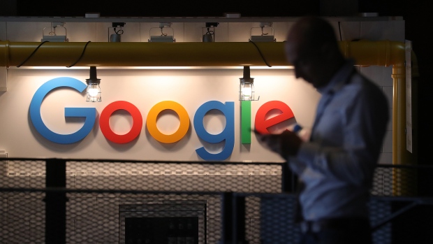 The Google logo sits illuminated on the company's exhibition stand at the Noah Technology Conference in Berlin, Germany June 6, 2018