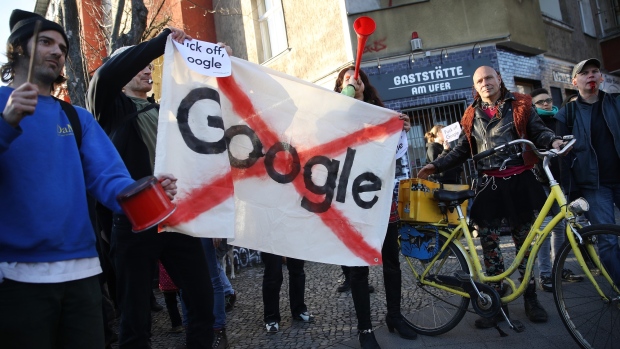 BERLIN, GERMANY - APRIL 06: (EDITORS NOTE: Image contains profanity.) Protesters make noise outside the Umspannwerk building where U.S. tech company Google is to open a Google Campus for startups on April 6, 2018 in Berlin, Germany. Approximately 100 demonstrators beat pots and pans and blew into horns. The project, in traditionally left-leaning Kreuzberg district, has provoked the ire of many local residents, who fear the Google Campus will accelerate gentrification in the area. (Photo by Sean Gallup/Getty Images)