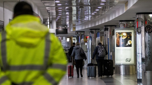 Travelers pull luggage at LaGuardia Airport in New York. 