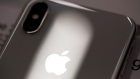 A logo sits on the case of an iPhone X smartphone on the first day of sale Customers queue at a re:Store Apple Inc. retailer in Moscow, Russia, on Friday, Nov. 3, 2017. Supported by resurgent iPad and Mac sales, the 10-year anniversary iPhone will help push revenue to a record high of $84 billion to $87 billion in the quarter ending in late December, Apple said in a statement. 