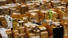 A worker picks an item for a customer's order at an Amazon.com Inc. fulfillment center in Peterborough, U.K. 