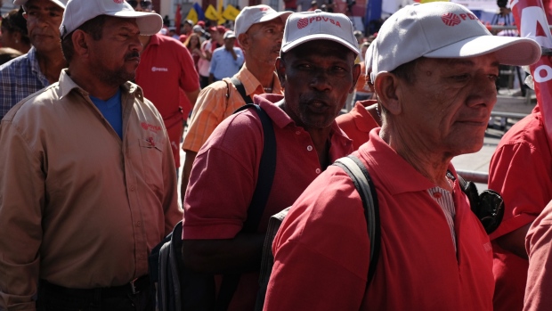 Pro-government supporters wearing hats with the Petroleos de Venezuela SA (PDVSA) logo attend a rally in Caracas, Venezuela, on Thursday, Jan. 31, 2019. The U.S. and more than a dozen other nations have recognized National Assembly President Juan Guaido as Venezuela's legitimate leader and are pressuring President Nicolas Maduro to step down, accusing him of rigging his re-election last year and leading the once-rich country into ruinous poverty. 