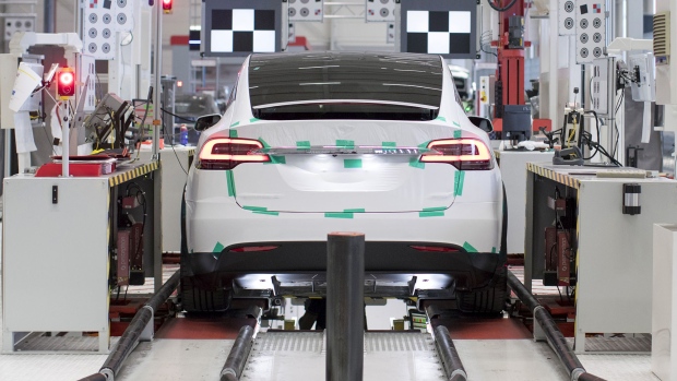 A Tesla Model X sports utility vehicle (SUV) undergoes wheel alignment checks during assembly for the European market at the Tesla Motors Inc. factory in Tilburg, Netherlands. 