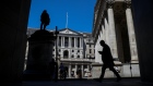 A pedestrian passes the Bank of England in the City of London. 