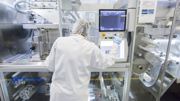 An employee monitors machine inside Merck KGaA's pharmaceutical laboratories at the company's headquarters in Darmstadt, Germany. 