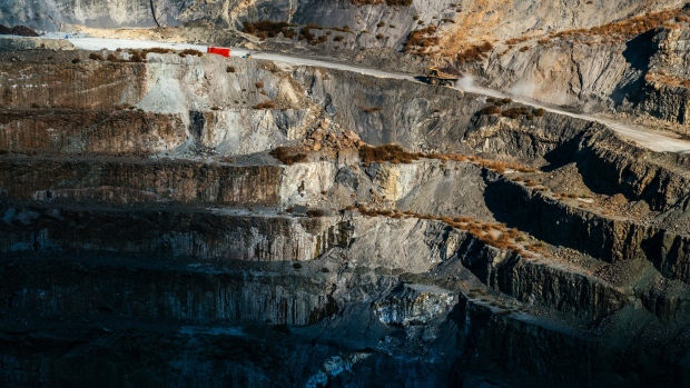 A truck carries newly excavated kimberlite rock out of the open pit at the Voorspoed diamond mine, operated by De Beers SA, in Kroonstad, South Africa, on Tuesday, May 3, 2017. The Anglo American Plc unit plans to store carbon-dioxide in kimberlite -- a type of ore best known for containing diamonds, but which also naturally reacts with carbon to remove it from the atmosphere. 