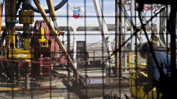 A Chevron Corp. flag flies on the drilling floor of a Nabors Industries Ltd. drill rig in the Permian Basin near Midland, Texas, U.S., on Thursday, March 1, 2018
