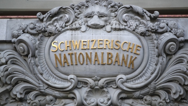 A Swiss National Bank (SNB) logo sit above the the entrance to the central bank in Bern, Switzerland, on Thursday, Dec. 13, 2018. The Swiss National Bank cut its inflation forecast and showed no inclination of moving off its crisis-era settings, citing the franc’s strength and mounting global risks. 